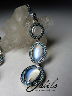 Moonstone gold earrings with blue diamonds